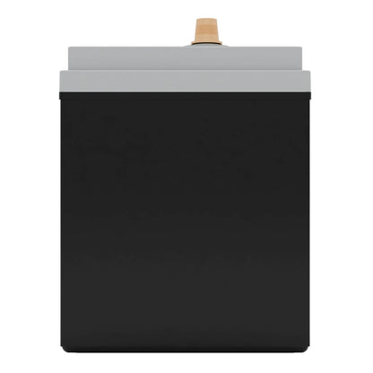 A black and gray rectangular object with a tan knob on top, likely an electronic or industrial device.
